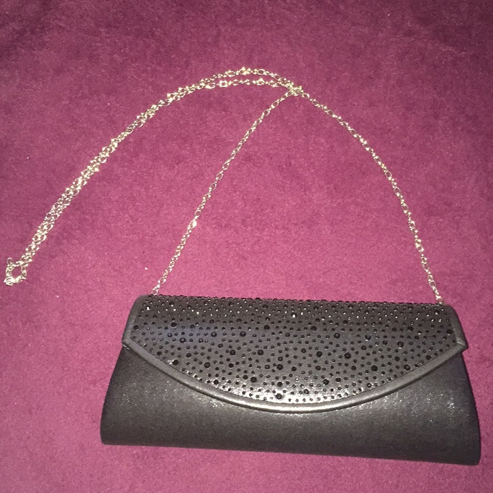 A black clutch/ shoulder purse.